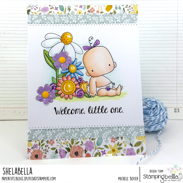 Handmade card design featuring Stamping Bella Baby Boy & Girl cling mounted rubber stamp set, Baby Sentiment Set, and Spring Backdrop stamp. The card shows a baby sitting among colorful flowers with the text 'Welcome, little one.' Floral patterns decorate the top and bottom borders. Created by Michele Boyer.