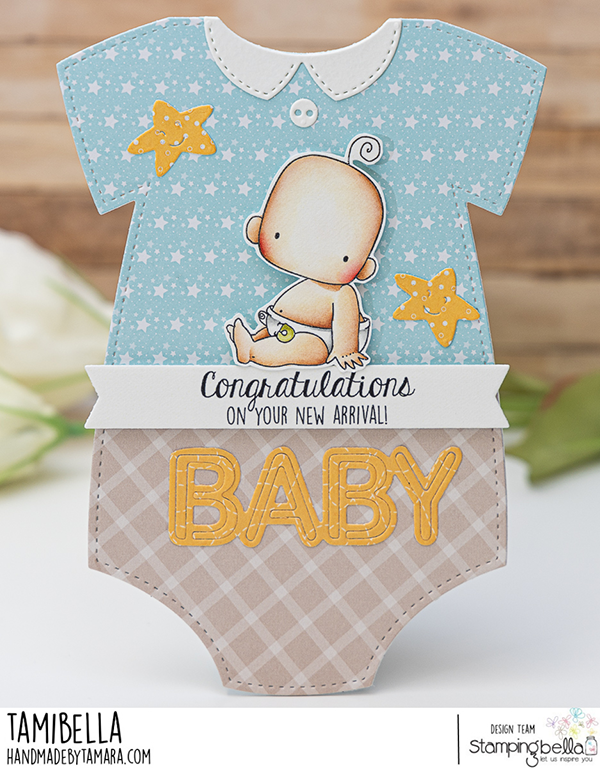 "Handmade baby card design featuring Stamping Bella Baby Boy & Girl and Baby Sentiment Set cling mounted rubber stamp sets. The card is shaped like a baby onesie with a blue top adorned with white stars and yellow star decorations, and a beige plaid bottom. A cute baby illustration is centered on the card, with the text 'Congratulations on your new arrival!' and 'BABY' in large yellow letters. Card designed by Tamara for Stamping Bella.