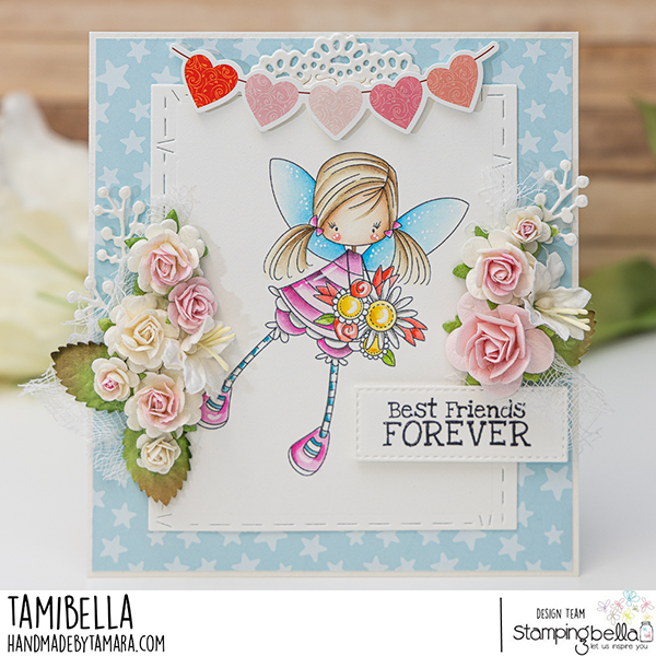 Handmade greeting card featuring a whimsical fairy girl, watercolored with Distress Inks, holding a bouquet of flowers. The card design includes Stamping Bella Whimsabella GlimmerGlade and Spec-Tacular Together Sentiment Set cling mounted rubber stamps. The card is adorned with pink and white paper flowers, a heart garland, and the sentiment 'Best Friends FOREVER' on a stitched rectangle panel. The background is light blue with white stars, and the card was crafted by Tamibella as part of the Stamping Bella design team.