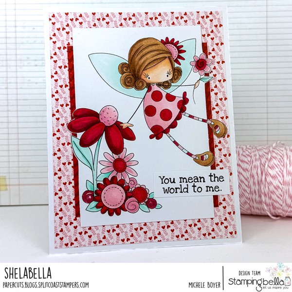 Handmade greeting card featuring Stamping Bella Whimsabella PetalShimmer and Spring Backdrop cling mounted rubber stamps and Spec-Tacular Together Sentiment Set. The whimsical fairy character is colored with Copic markers and shown with brown hair, wearing a red polka-dotted dress and holding a flower. The card is adorned with red and pink flowers and includes the sentiment 'You mean the world to me.' The background features a red and white heart pattern, adding a charming and heartfelt theme. Designed by Michele Boyer from the Stamping Bella design team.