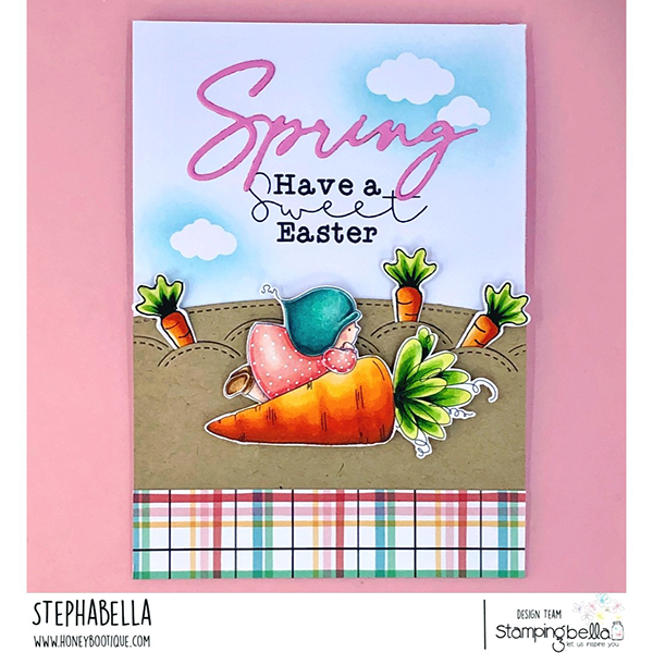 Handmade Easter greeting card featuring Stamping Bella Bundle Girl with a Carrot cling mounted rubber stamp. Showcasing a girl in a pink dress and blue bonnet leaning on a large carrot, the card has a whimsical garden with smaller carrots, a blue sky, and clouds. The text 'Spring Have a sweet Easter' is displayed in pink and black fonts. The card is finished with a colorful plaid pattern at the bottom, adding a charming handmade touch for the Easter holiday.